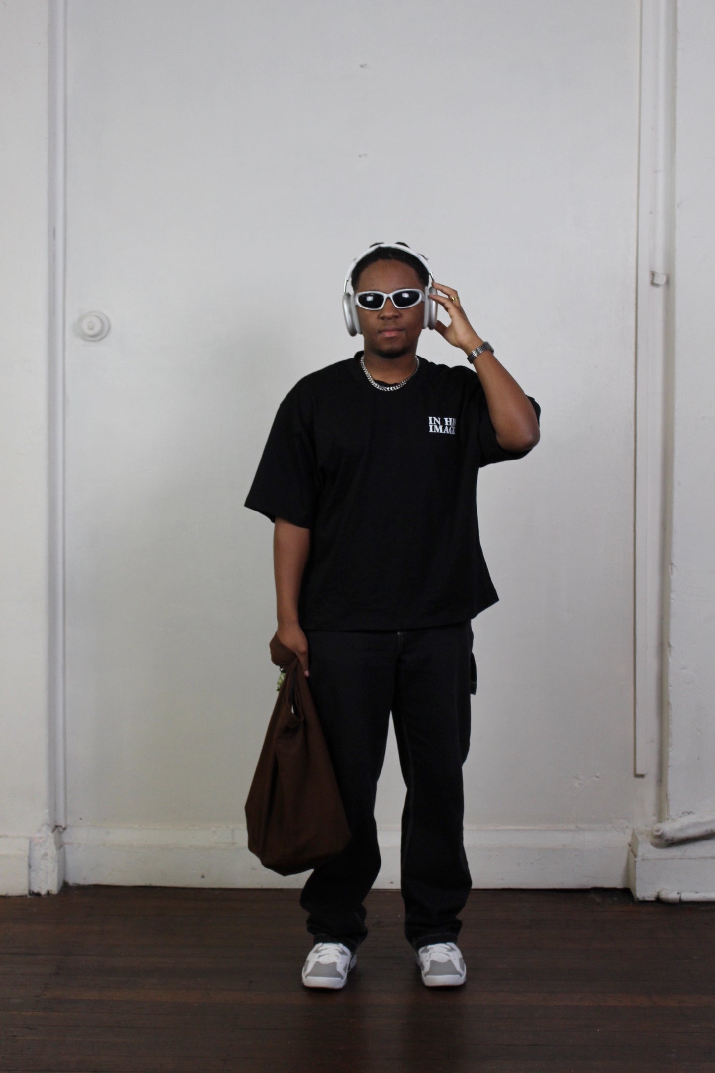 Front view of model wearing black oversized drop shoulder t-shirt featuring distressed thumbprint graphic inspired by Genesis 1:26-27